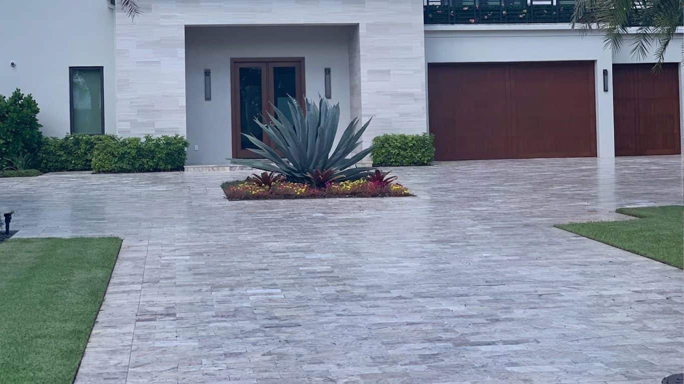 Silver travertine paver driveway on a modern South Florida home