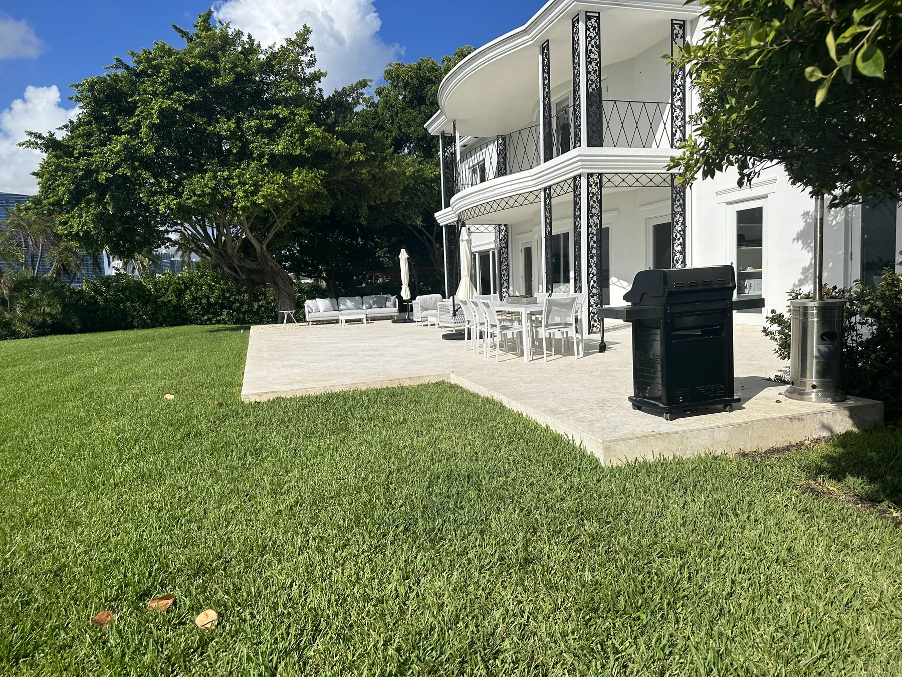 Coral stone patio connecting a white Miami Beach home with its outdoor living area