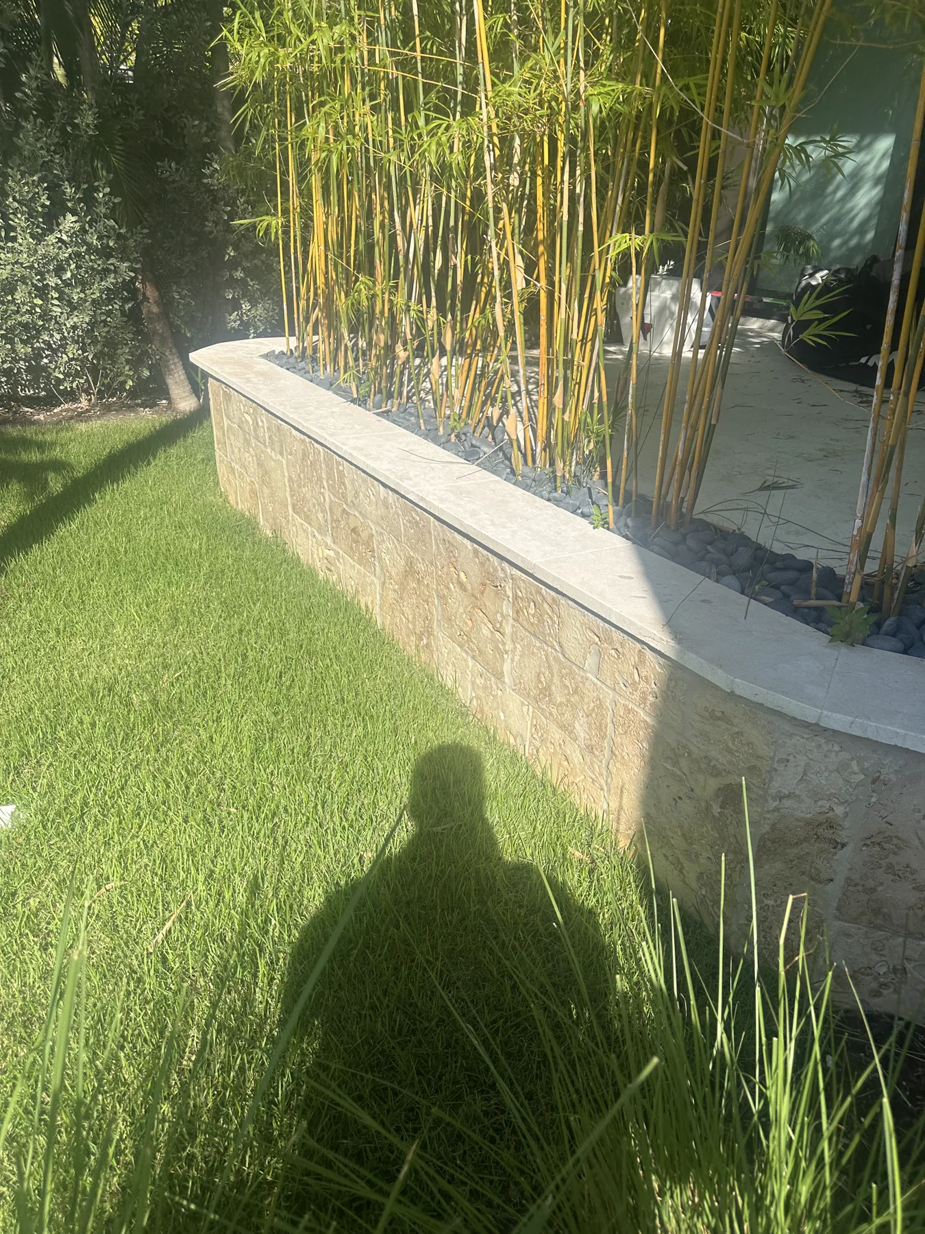 Low landscape planter wall finished with oolite stone cladding