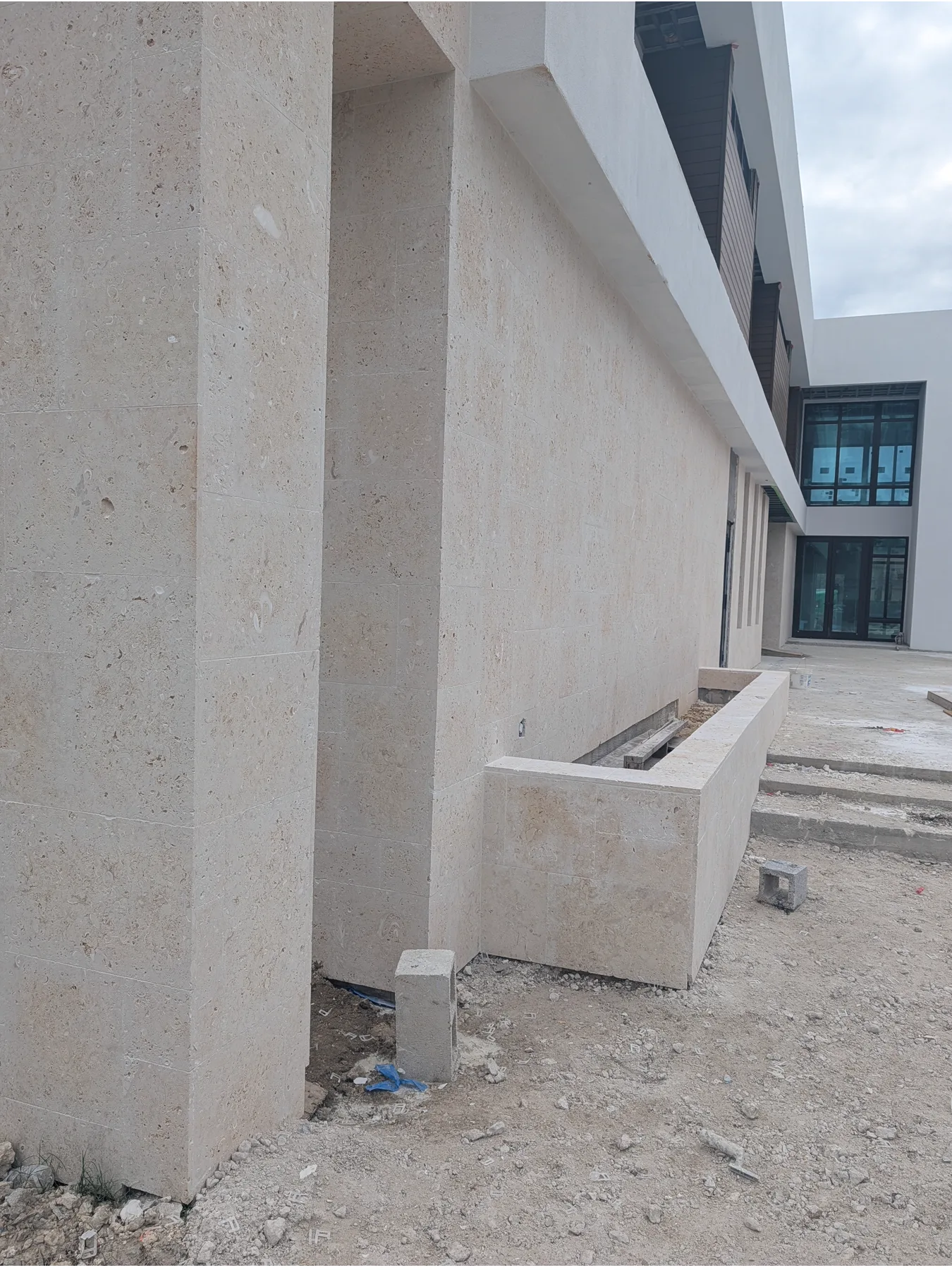 Close view of a coral stone entry column during installation