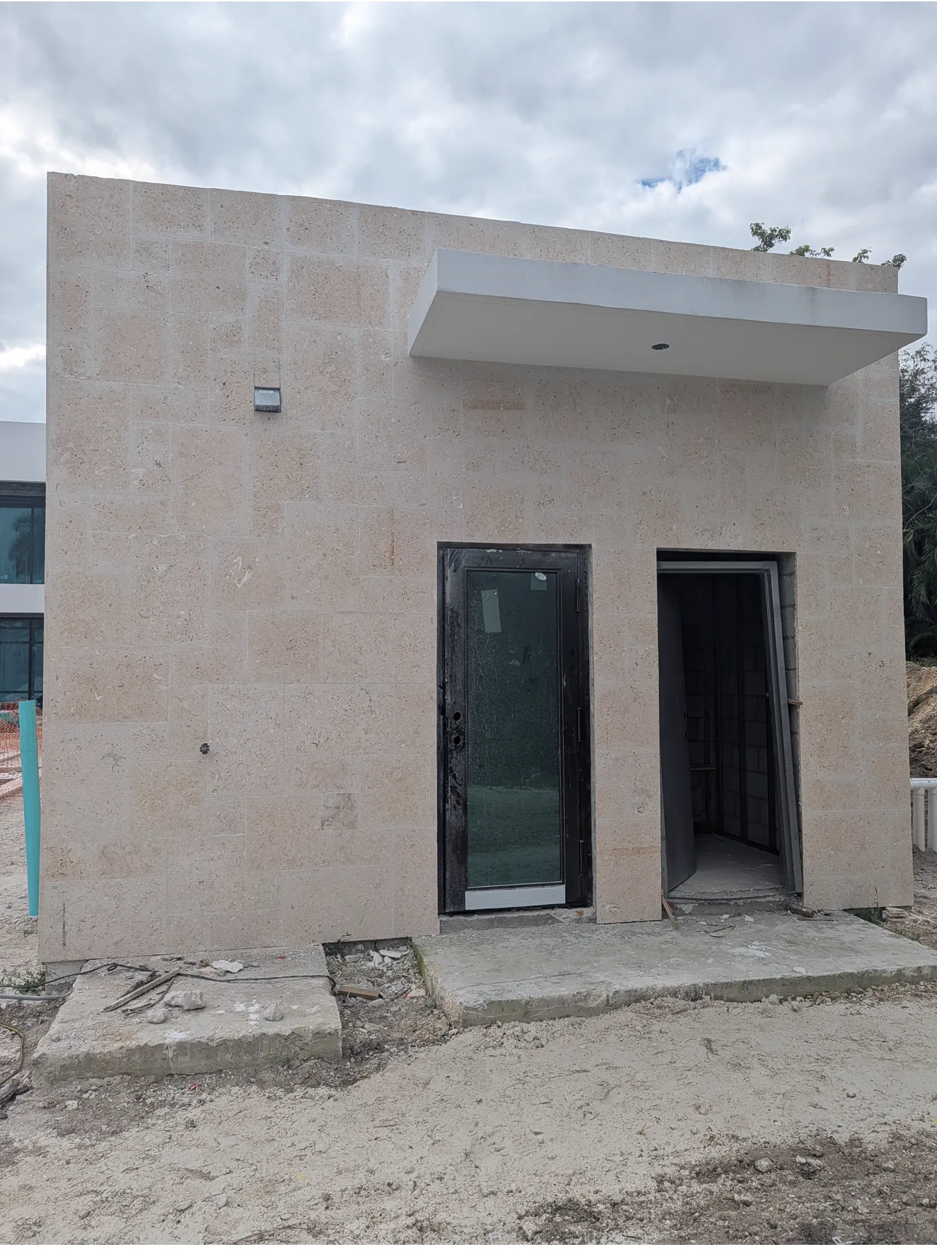 Small exterior volume fully finished with coral stone cladding
