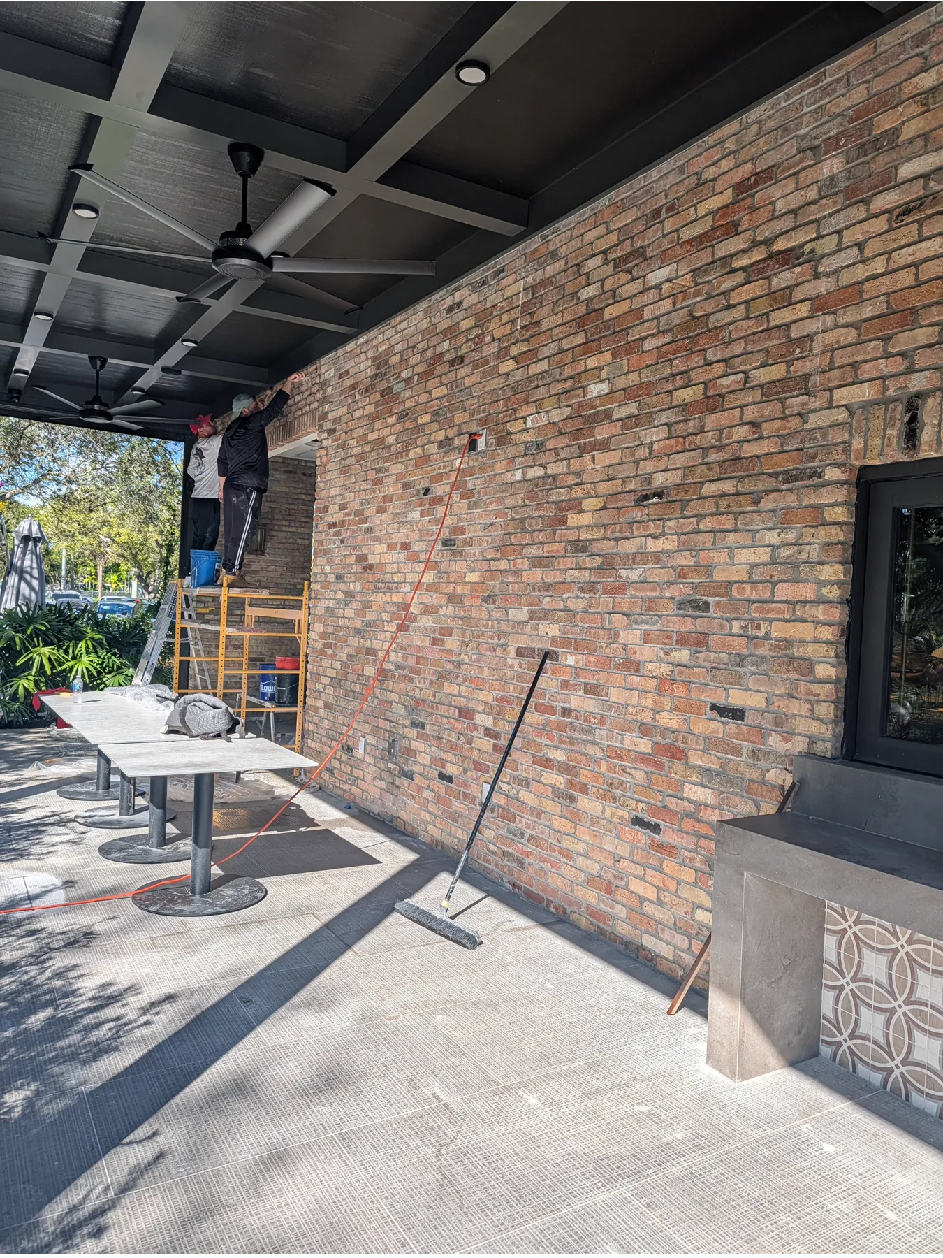 Covered restaurant patio surrounded by Old Chicago brick walls