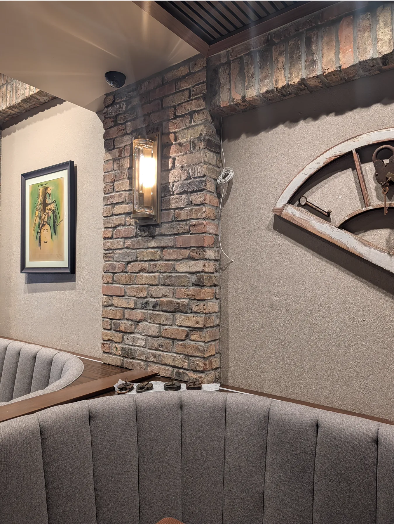 Brick-framed mural wall and curved restaurant seating