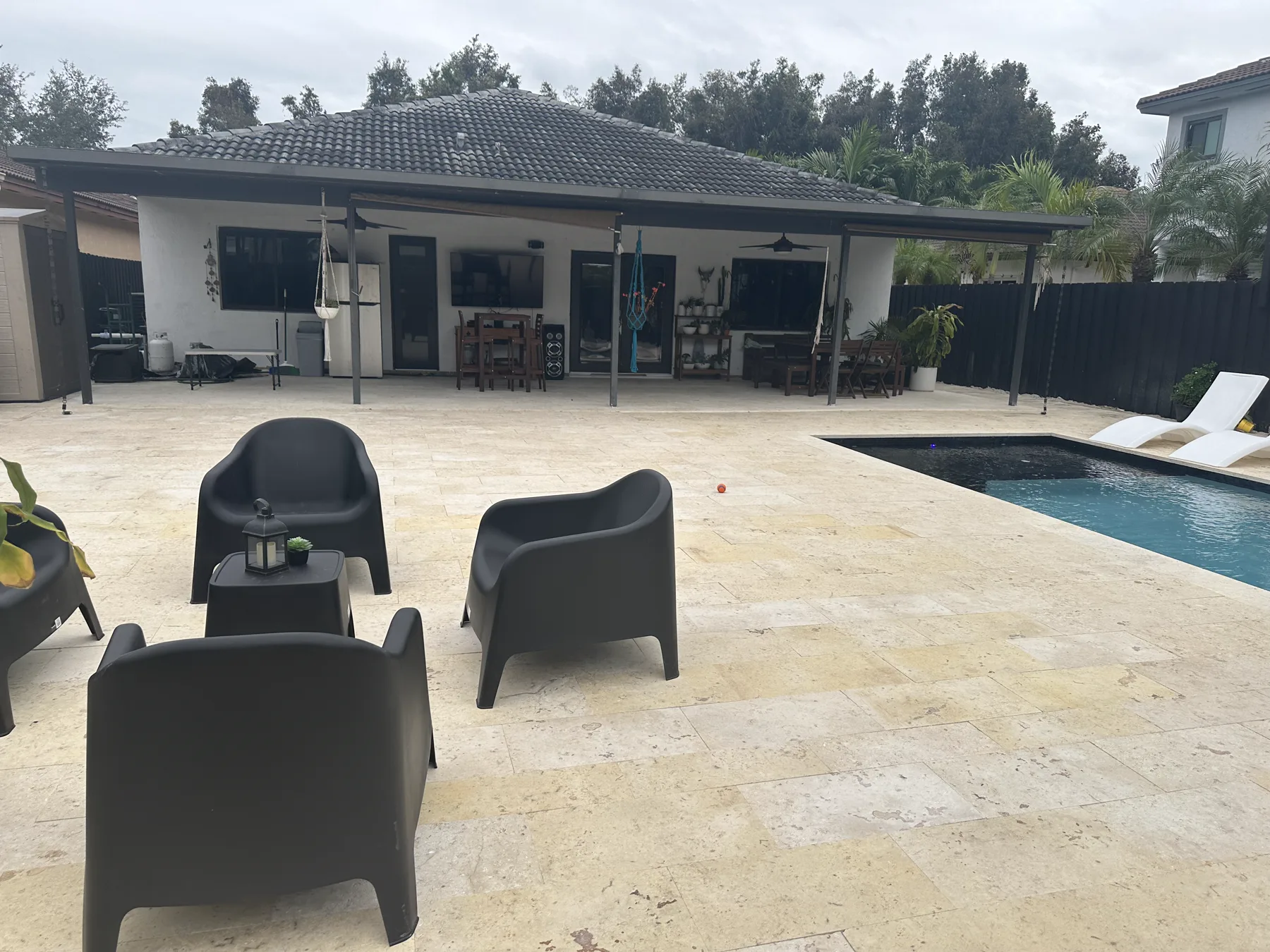 Wide view of the finished coral stone patio and pool in South Miami