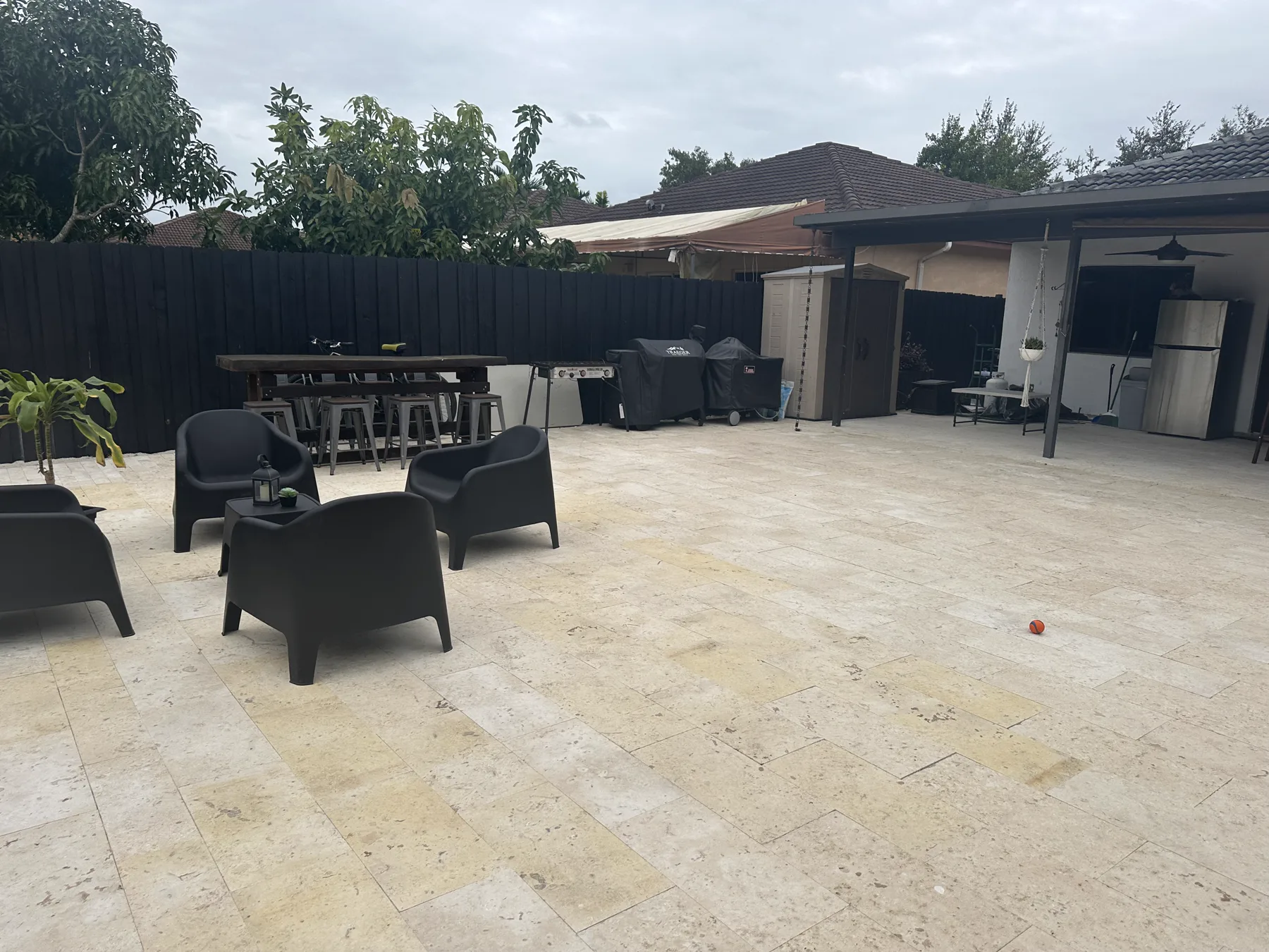 Furnished coral stone outdoor living area beside a South Miami pool