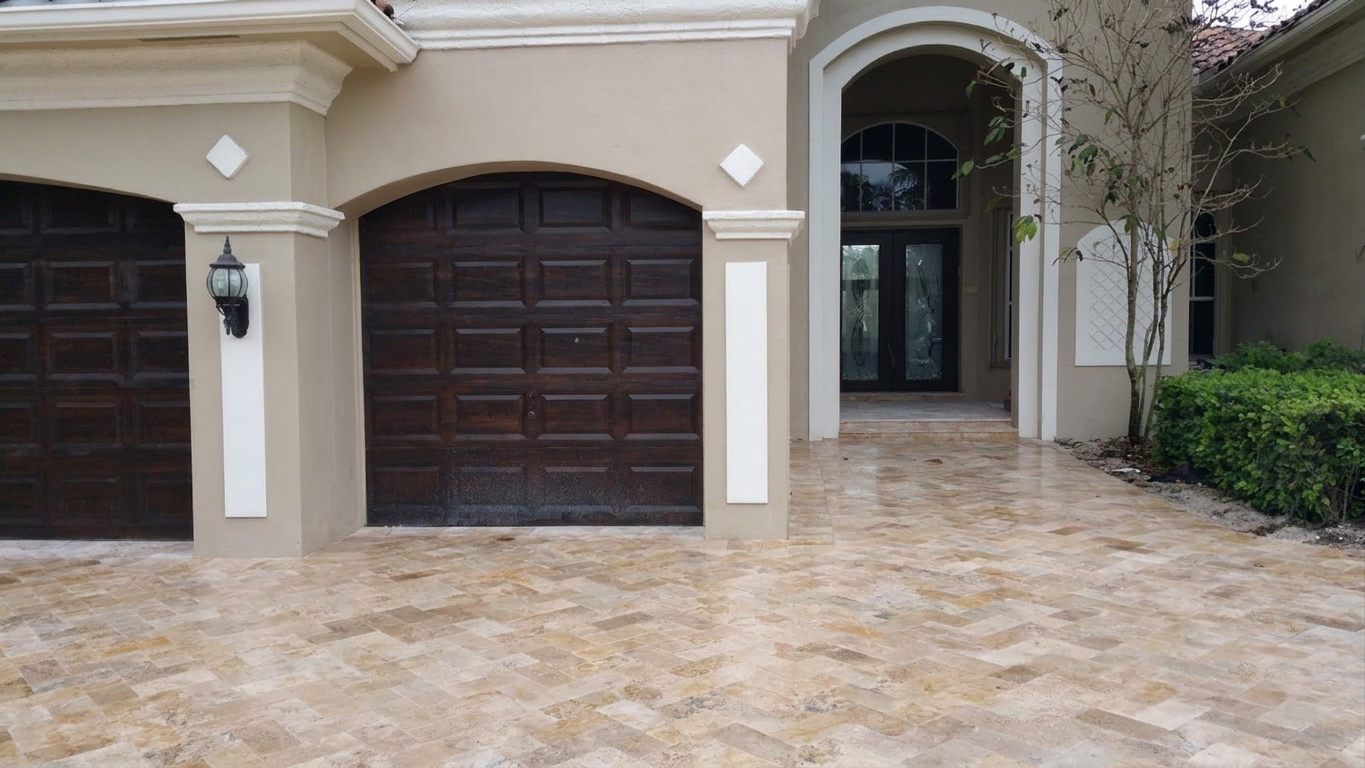 Travertine herringbone driveway installed by Driveway & Paver Solutions
