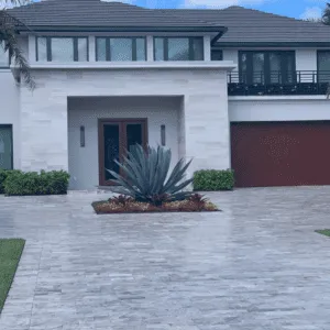 Elegant driveway paved with travertine stone.