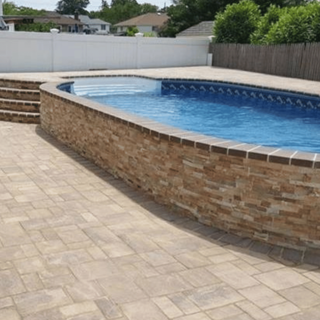 Above-ground pool with a natural stone deck.