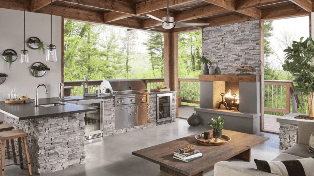 Luxury outdoor kitchen and lounge area with stainless steel appliances and grey stacked stone masonry installation
