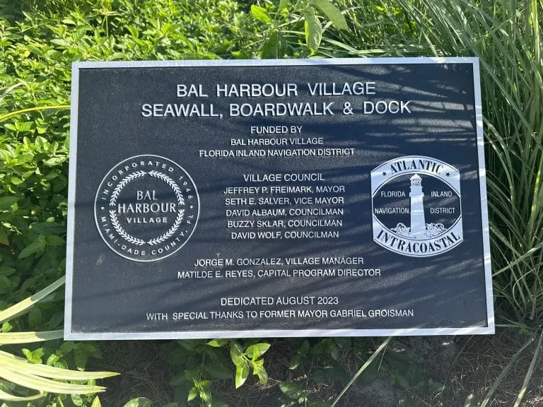 Black dedication plaque for the Bal Harbour Village Seawall, Boardwalk & Dock project, dated August 2023.